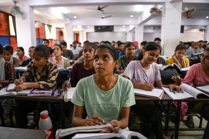 Students attend a coaching institute class in Prayagraj, India, as the CBSE exam scandal exposed by three teenagers grows