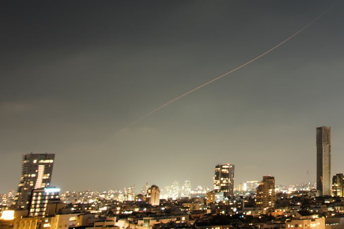 Iranian missile projectile streaks over central Israel during June 2026 ceasefire breakdown