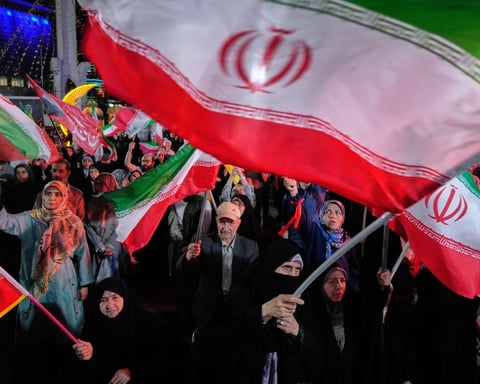 Demonstrators wave Iranian flags at a pro-government rally in Tehran