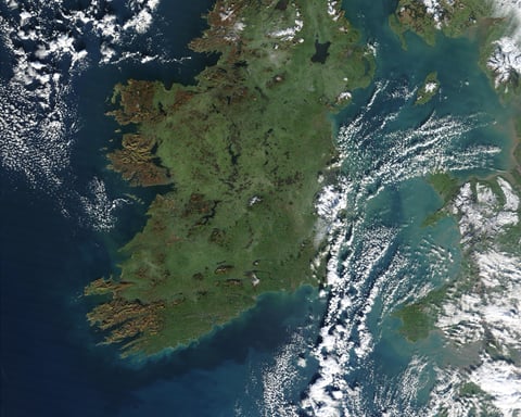 NASA MODIS Aqua satellite image of Ireland on a clear day showing the green interior landscape with Belfast on the northeast coast east of Lough Neagh Derry on the northwest and Dublin on the east coast of the Republic