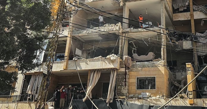 First responders inspect damage at apartment building hit by Israeli airstrike in Beirut Dahiyeh suburb June 2026