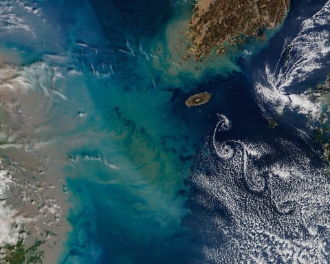 NASA Terra MODIS image of Jeju Island Korea Strait February 19 2026 with sediment plume from Chinese coast and cloud vortices