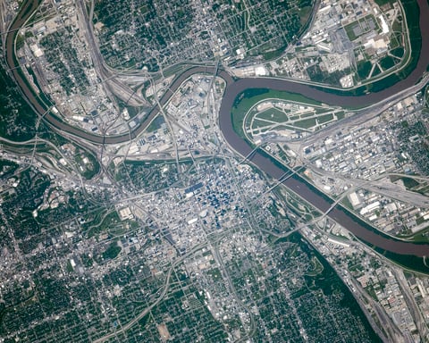 NASA astronaut photograph from the International Space Station of the Kansas City metropolitan area showing the Missouri and Kansas rivers meeting with the Kansas City Missouri urban grid on one side and Kansas City Kansas on the other