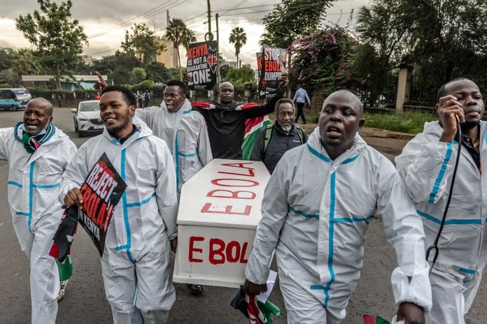 Activists carry a mock coffin during a protest against the US-built Ebola quarantine centre in Kenya