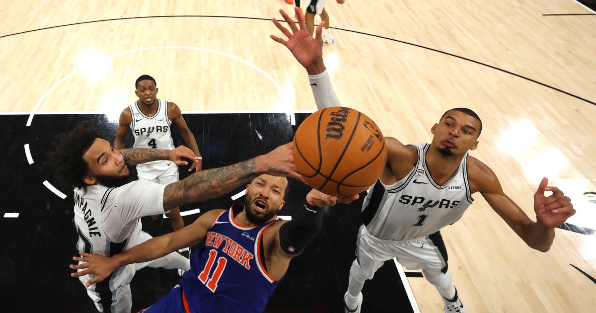 Jalen Brunson of the New York Knicks shoots between Julian Champagnie and Victor Wembanyama of the San Antonio Spurs in Game 2 of the 2026 NBA Finals