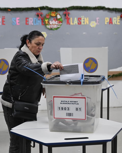 A voter casts a ballot at a polling station in Pristina during Kosovo's snap election