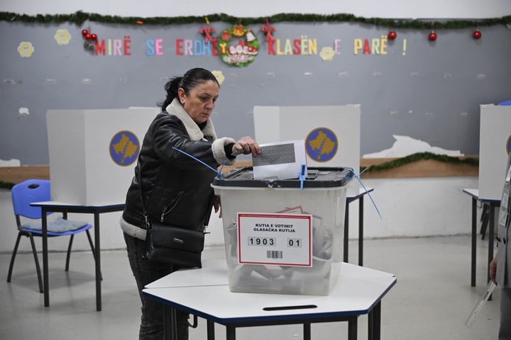 A voter casts a ballot at a polling station in Pristina during Kosovo's snap election