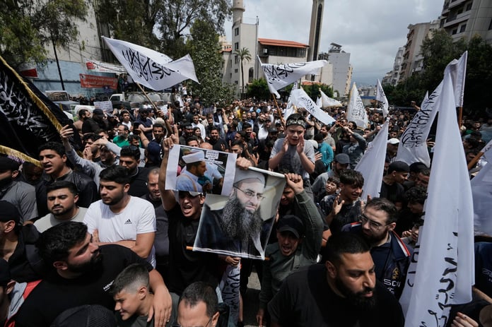 Sunni Muslims hold portrait of imprisoned cleric Ahmad al-Assir during protest against Lebanon amnesty law in Beirut