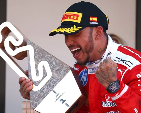 Lewis Hamilton crosses the finish line in Ferrari red at the 2026 Barcelona-Catalunya Grand Prix for his maiden Ferrari Formula One win