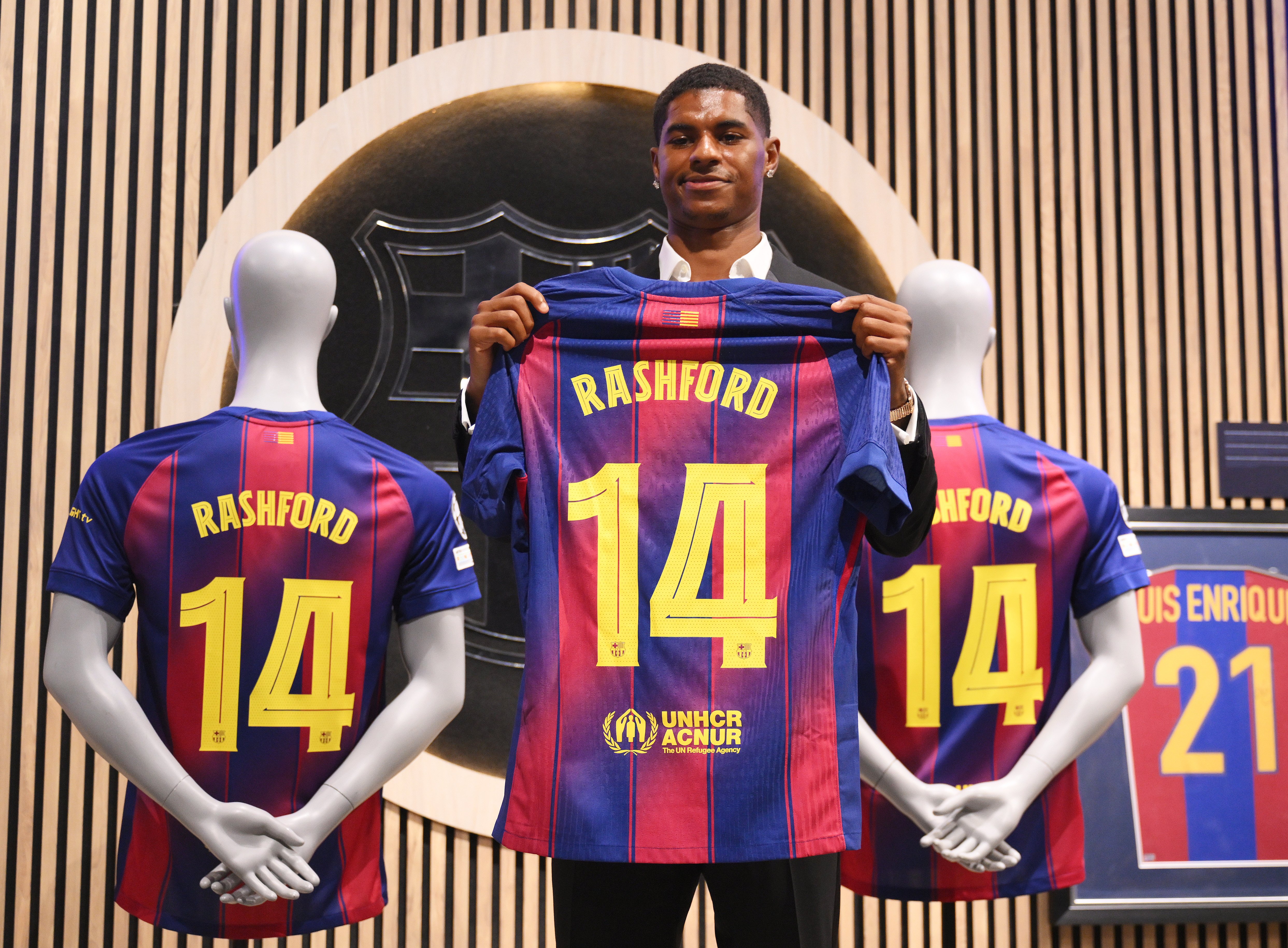Marcus Rashford holds up his Barcelona shirt at his unveiling at the Camp Nou in July 2025, ahead of a loan spell that has complicated his Manchester United future