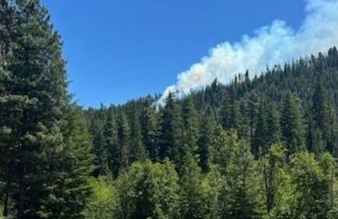 Smoke rises from the crash site of a Marine Corps F/A-18 Hornet near Rimrock Lake in Yakima County Washington