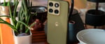Motorola Edge 2026 in Pantone Martini Olive on a table next to a potted plant
