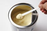 Powdered infant formula in a container with a scoop, illustrating the Nara Organics recall over botulism