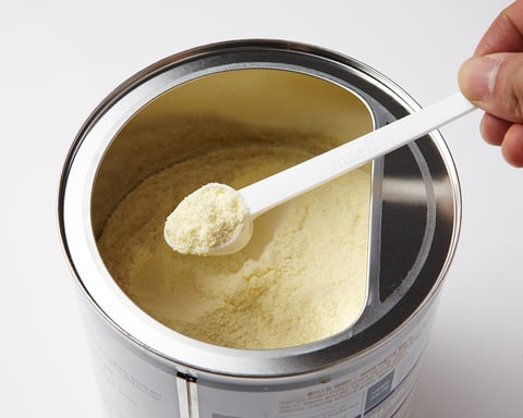 Powdered infant formula in a container with a scoop, illustrating the Nara Organics recall over botulism