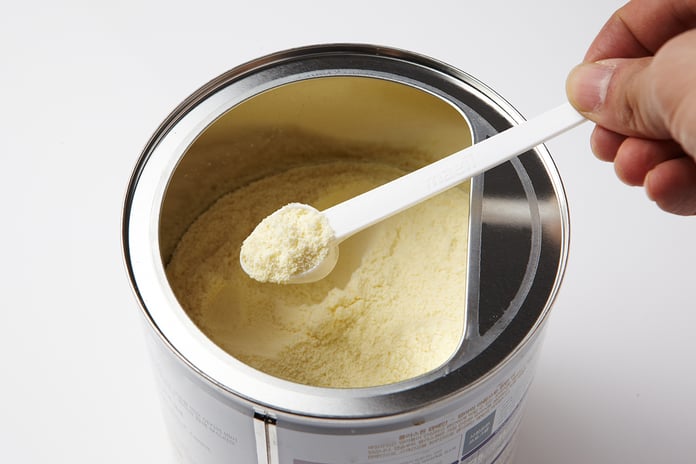 Powdered infant formula in a container with a scoop, illustrating the Nara Organics recall over botulism