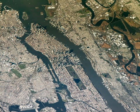 NASA astronaut photograph from the International Space Station of New York City and New Jersey from an oblique angle showing Manhattan the Hudson River New Jersey and the East Rutherford MetLife Stadium area