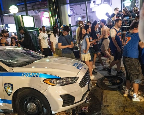 NYPD officers in riot gear amid Knicks championship celebration violence in Times Square New York 2026