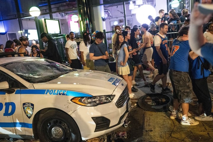 NYPD officers in riot gear amid Knicks championship celebration violence in Times Square New York 2026