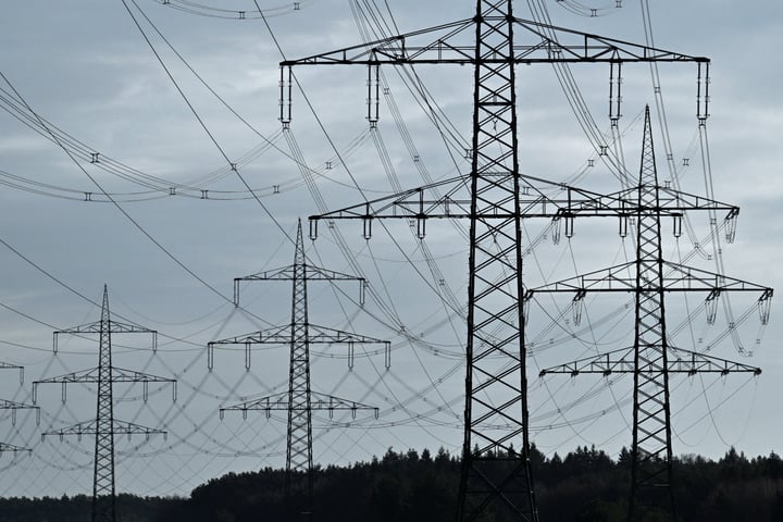 High-voltage power lines and electricity pylons near the A24 motorway in Germany, illustrating the COP31 electrification target