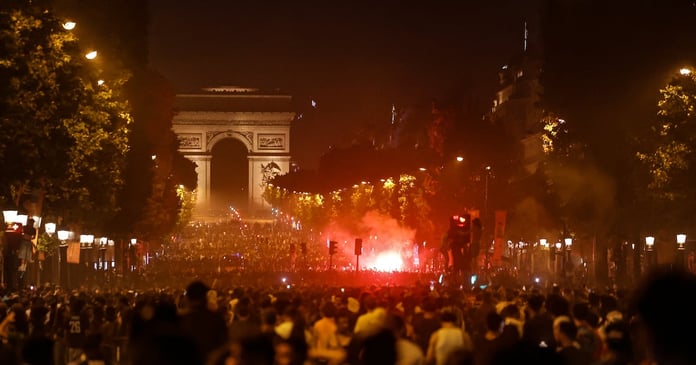 PSG fans gather on the Champs-Elysees in Paris after Champions League win over Arsenal in Budapest
