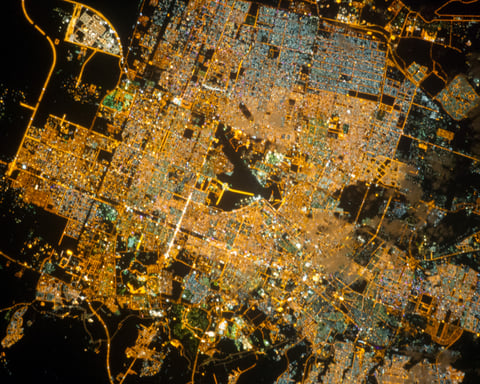 NASA astronaut photograph of Riyadh Saudi Arabia at night from the International Space Station showing the brightly illuminated capital radiating along ring roads from a glowing central business district