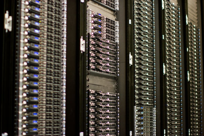 Rows of server racks in a data center, the kind of hardware behind Super Micro's 39 billion dollar AI order backlog