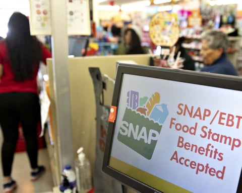 A SNAP and EBT food stamp benefits accepted sign in a store