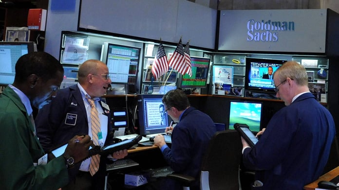 Traders work on the floor of the New York Stock Exchange as S&P 500 closes above 7,600 for the first time