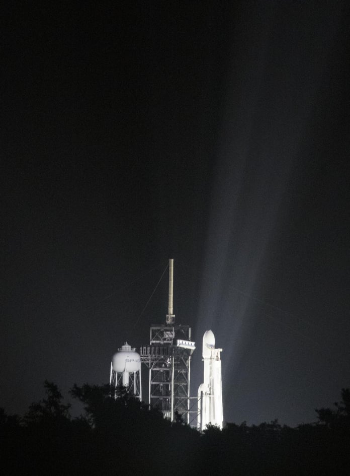 A SpaceX Falcon Heavy rocket lifts off at night from Kennedy Space Center