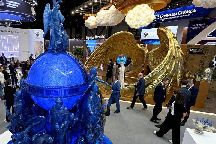 Participants tour the exhibition hall at SPIEF 2026 in St. Petersburg Russia