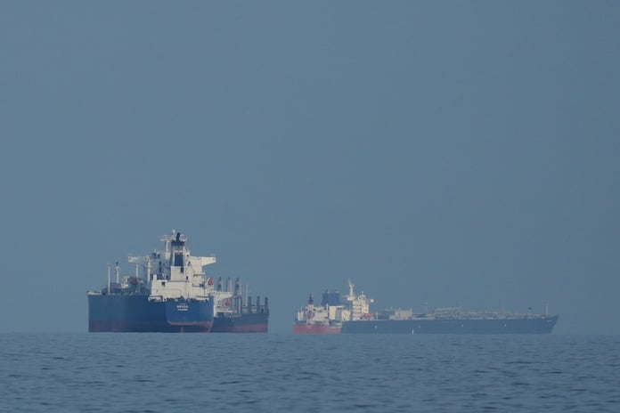 Oil tankers and cargo ships anchored in the Strait of Hormuz near Khor Fakkan, United Arab Emirates