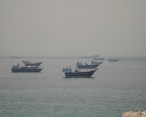 Vessels anchored in the Strait of Hormuz seen from Oman as Pakistan confirms the US-Iran peace deal text is final