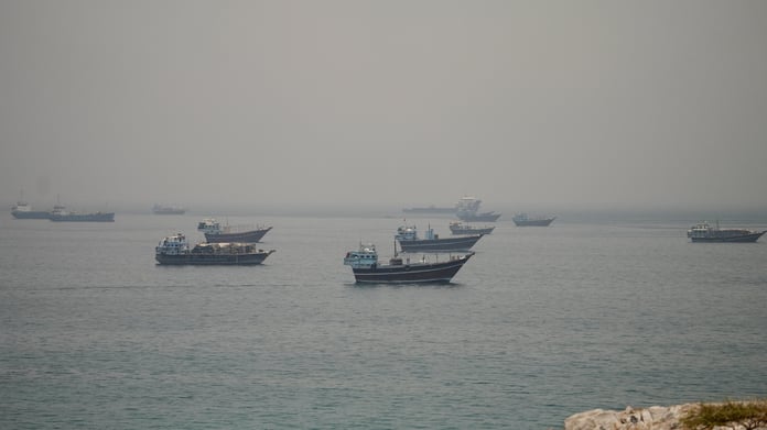 Vessels anchored in the Strait of Hormuz seen from Oman as Pakistan confirms the US-Iran peace deal text is final