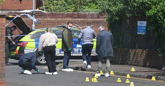 PSNI forensic officers investigate the scene of the stabbing attack on Kinnaird Avenue in north Belfast, Northern Ireland
