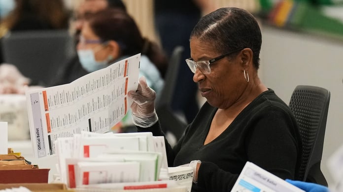 Election workers inspect mail-in ballots at the Los Angeles County Ballot Processing Center during California primary 2026