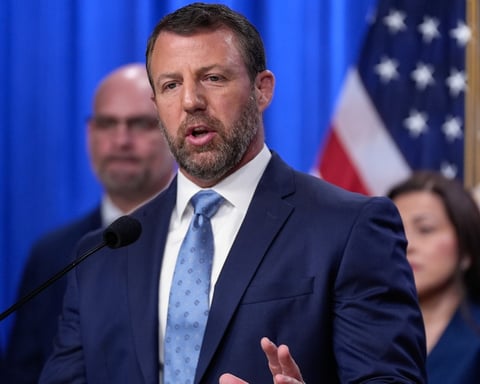 A Homeland Security official speaks at a Justice Department news conference on migrant children