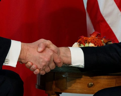 Trump shakes hands with Macron during a meeting at the U.S. Embassy in Brussels, May 2017