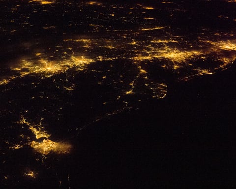NASA astronaut photograph from the International Space Station of the United States Atlantic Seaboard at night with Boston, New York, Philadelphia, Baltimore, and Washington DC visible as connected bright urban regions