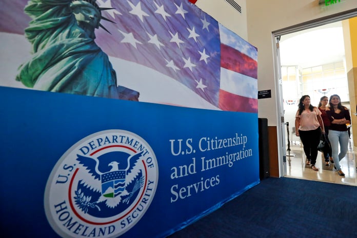 People arrive for a naturalization ceremony at a US Citizenship and Immigration Services office in Miami