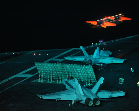 An F A-18E Super Hornet launches at night from the aircraft carrier USS Abraham Lincoln in the Gulf of Oman
