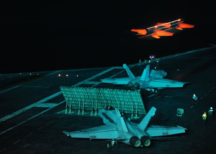 An F A-18E Super Hornet launches at night from the aircraft carrier USS Abraham Lincoln in the Gulf of Oman