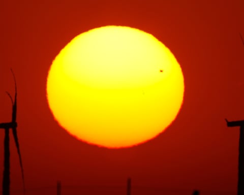 Wind turbines silhouetted at sunset in a field near Cimarron, Kansas, where Pentagon reviews have stalled new wind projects