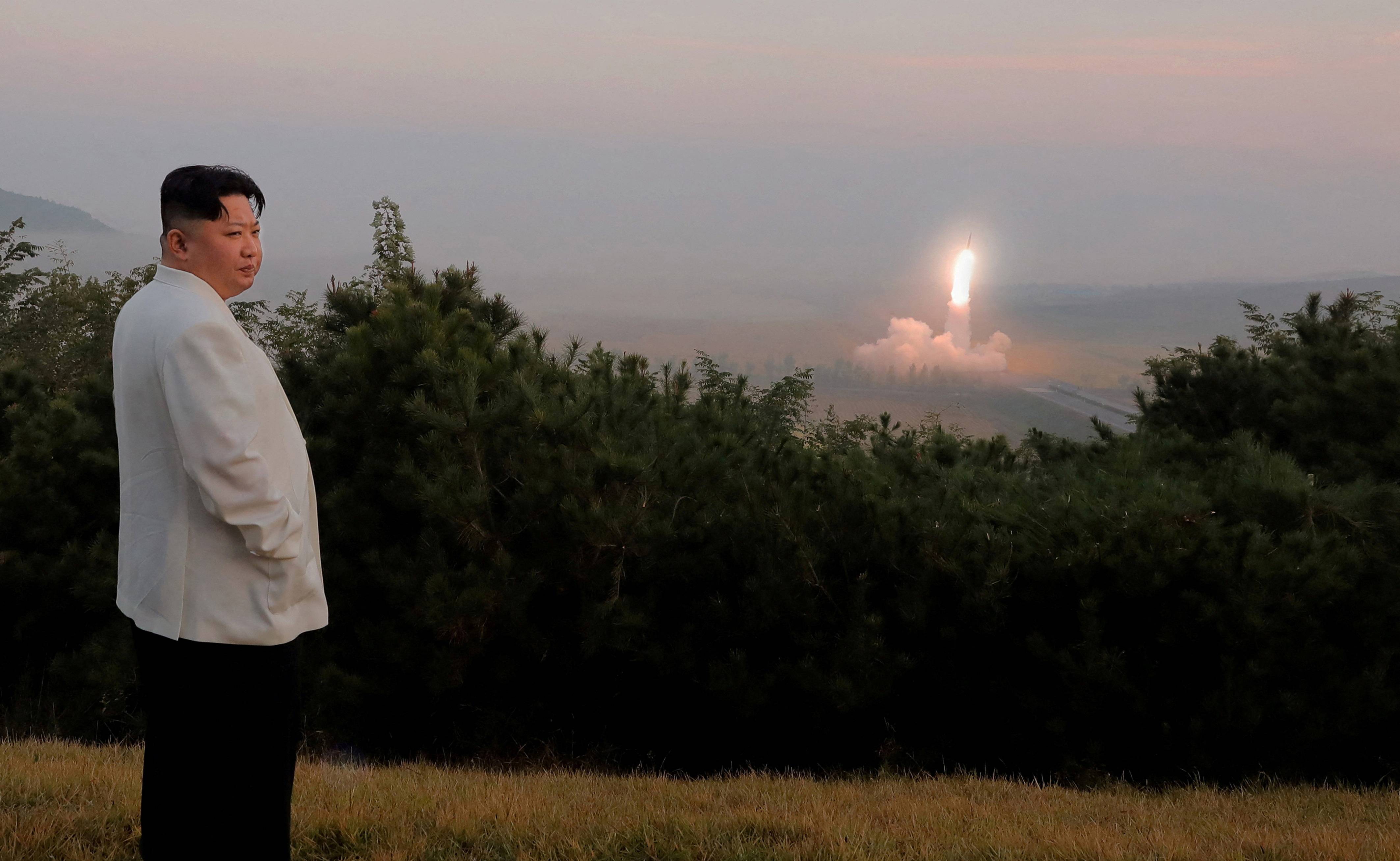 North Korea's leader Kim Jong Un oversees a missile launch at an undisclosed location in North Korea