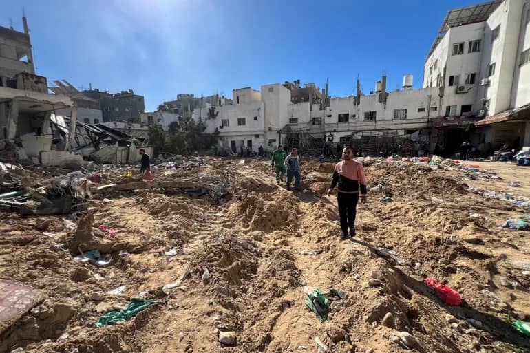 Palestinians assess damage following an Israeli raid at Kamal Adwan Hospital