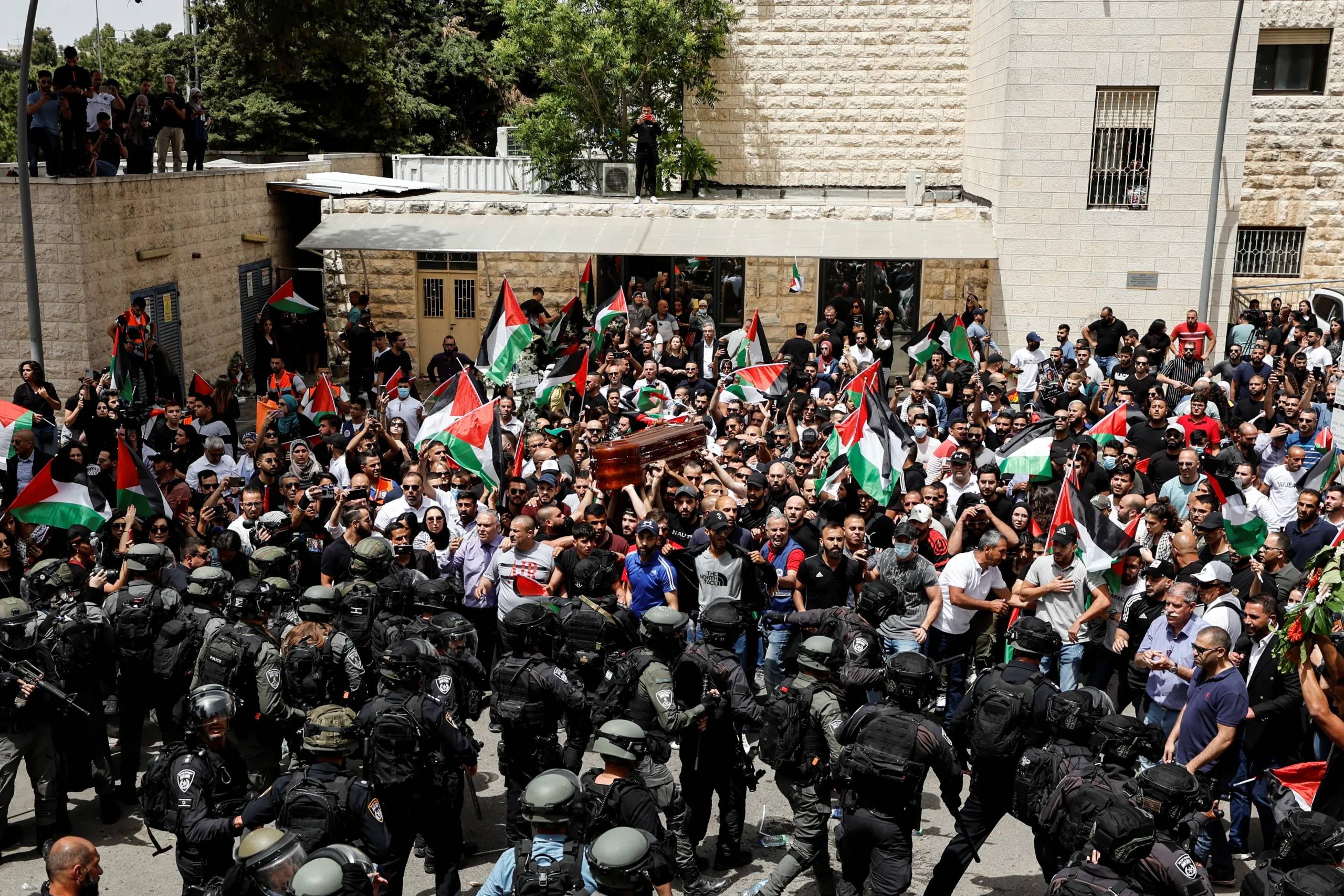 Mourners carry coffins draped in Palestinian flags during the funeral of Al Jazeera journalists killed in an Israeli airstrike on Gaza City