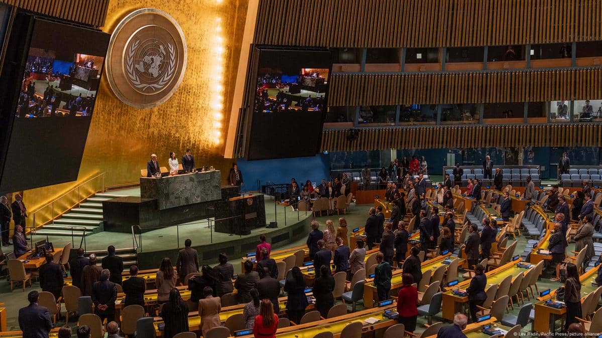 UN General Assembly hall during the vote backing a time-bound two-state plan; scoreboard shows 142-10-12 as US and Israel vote no