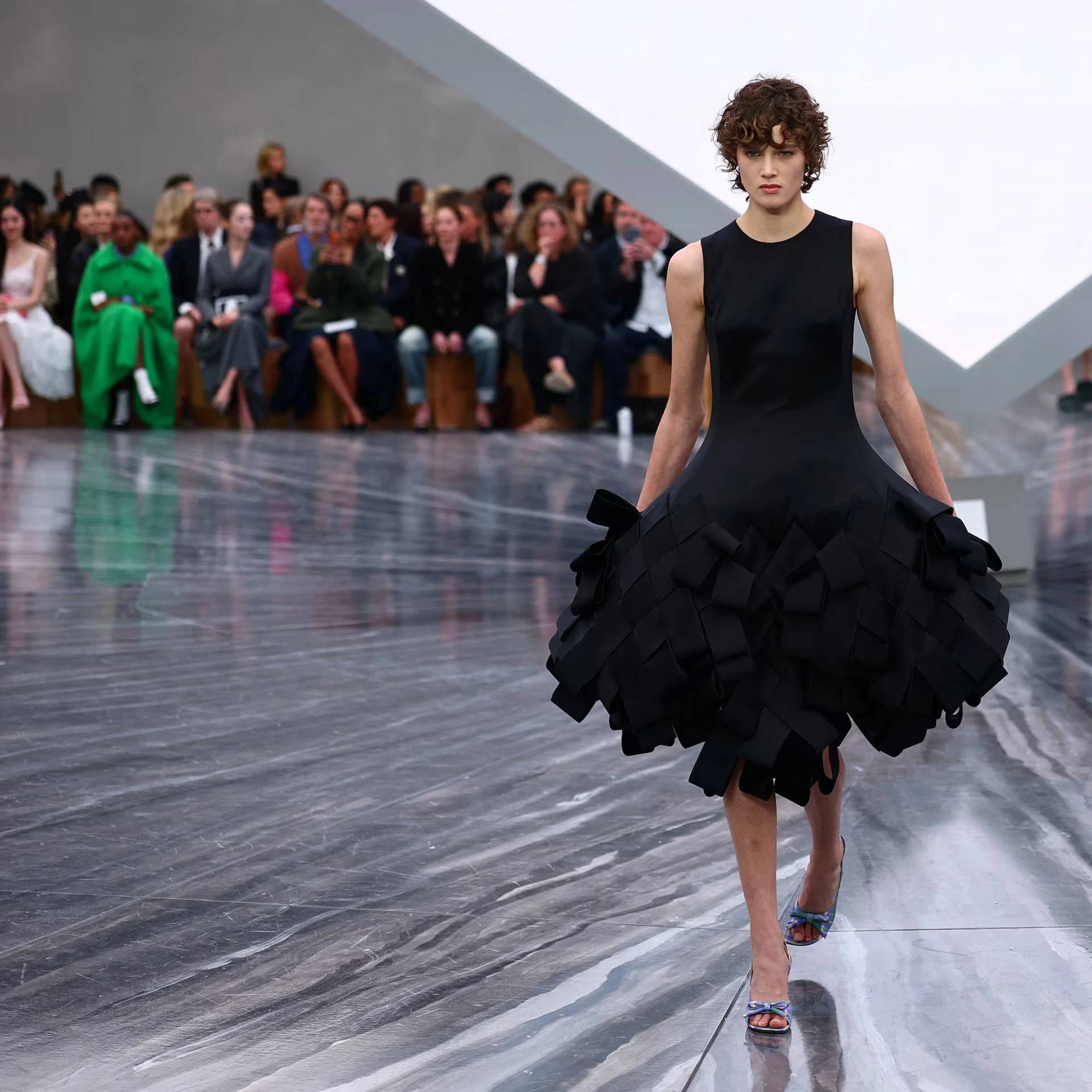 Model in pleated bow dress during Jonathan Anderson’s Dior womenswear debut at the Tuileries in Paris, Spring/Summer 2026