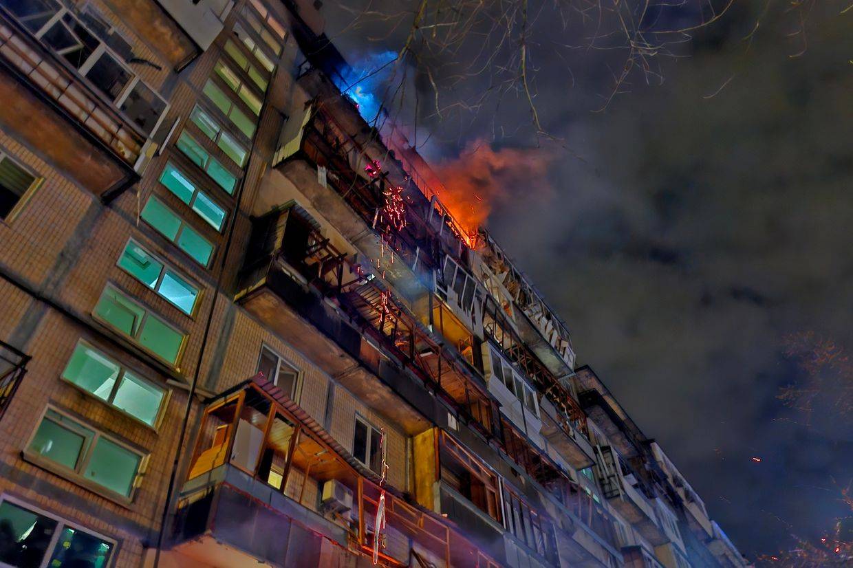 Firefighters evacuate residents from a smoke-filled Kyiv apartment block after a night drone strike.