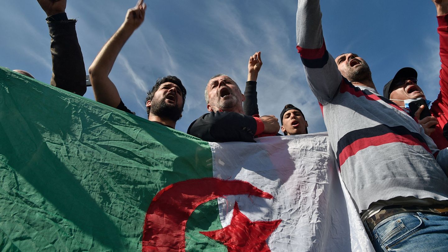 Algerians protesting outside Kolea prison near Tipasa carrying the national flag during Hirak movement anniversary demonstrations