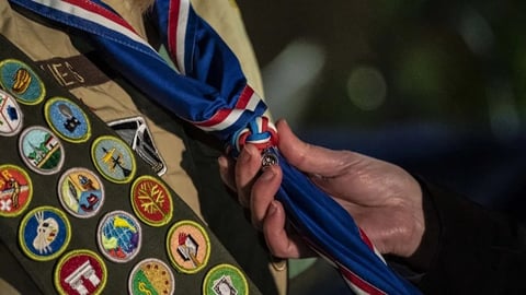 Boy Scouts of America members at a ceremony as the organization files for Chapter 11 bankruptcy